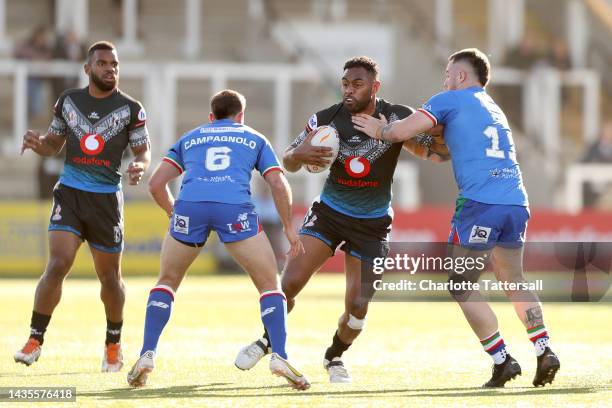 King Vuniyayawa of Fiji is tackled by Ryan King of Italy during the Rugby League World Cup 2021 Pool B match between Fiji and Italy at Kingston Park...