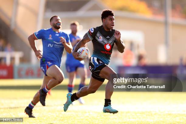 Kevin Naiqama of Fiji breaks with the ball to score their team's second try during the Rugby League World Cup 2021 Pool B match between Fiji and...