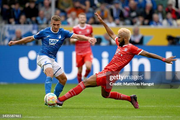 Grischa Proemel of TSG 1899 Hoffenheim is challenged by Eric Maxim Choupo-Moting of Bayern Munich during the Bundesliga match between TSG Hoffenheim...