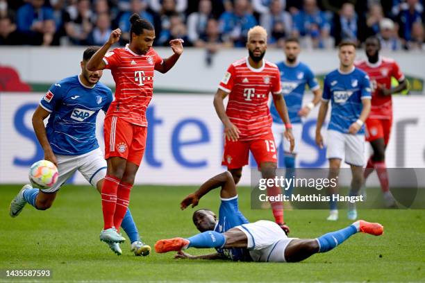 Serge Gnabry of Bayern Munich is challenged by Stanley Nsoki of TSG 1899 Hoffenheim during the Bundesliga match between TSG Hoffenheim and FC Bayern...