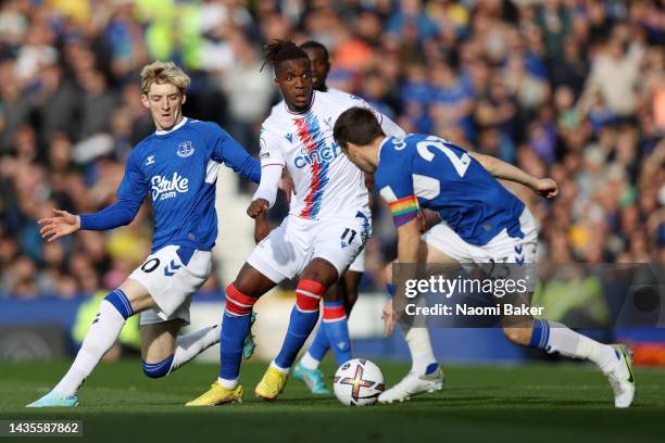 Wilfried Zaha of Crystal Palace battles for possession with Anthony Gordon and Seamus Coleman of Everton during the Premier League match between...
