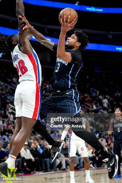 Chuma Okeke of the Orlando Magic shoots the ball against Isaiah Stewart of the Detroit Pistons at Little Caesars Arena on October 19, 2022 in...