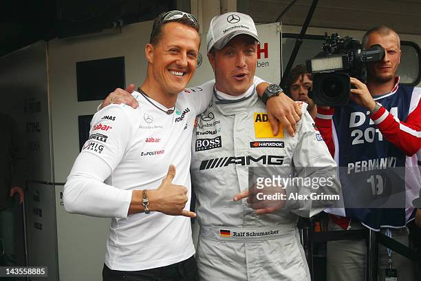Michael Schumacher and his brother Ralf pose prior to the first race of the DTM German Touring Car Championship at Hockenheimring on April 29, 2012...