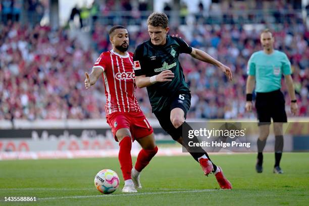 Daniel-Kofi Kyereh of SC Freiburg battles for possession with Jens Stage of SV Werder Bremen during the Bundesliga match between Sport-Club Freiburg...