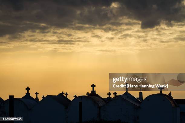 silhouette of tombstones against sunset sky - place of burial stock pictures, royalty-free photos & images