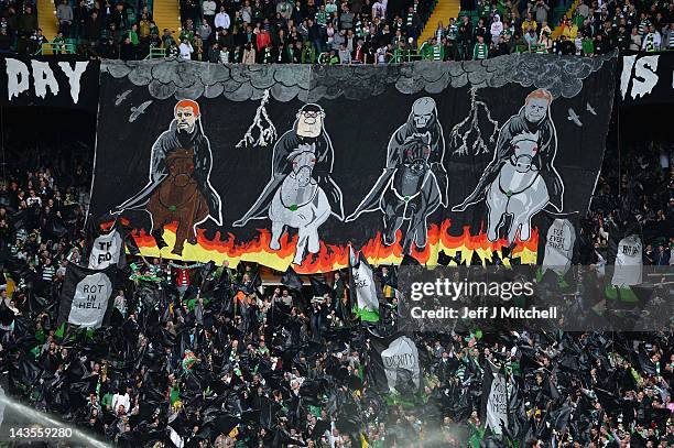 Celtic fans unveil a banner depicting their version of the four horsemen of the apocalypse during the Clydesdale Bank Premier League match between...