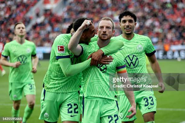 Maximilian Arnold of VfL Wolfsburg celebrates with teammates Felix Nmecha and Omar Marmoush after scoring their team's second goal during the...
