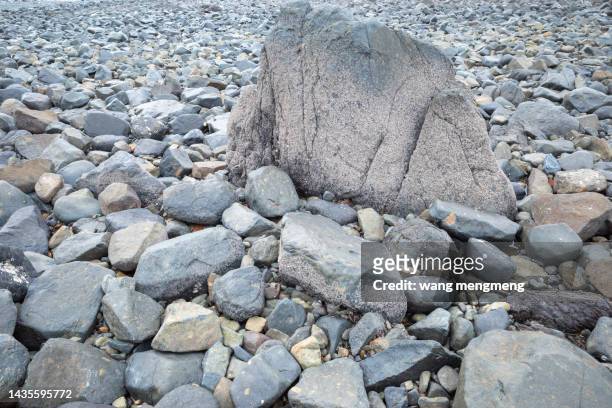 black stones on the beach by the sea - erosion stock pictures, royalty-free photos & images
