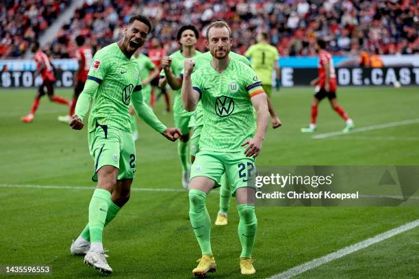 Maximilian Arnold of VfL Wolfsburg celebrates with teammate Felix Nmecha after scoring their team's second goal during the Bundesliga match between...