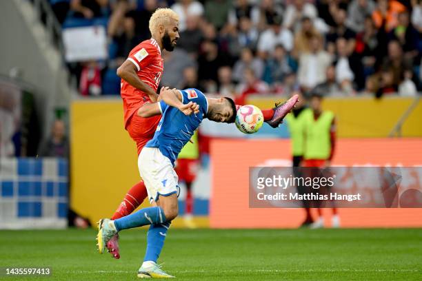 Eric Maxim Choupo-Moting of Bayern Munich is challenged by Ozan Kabak of TSG 1899 Hoffenheim during the Bundesliga match between TSG Hoffenheim and...