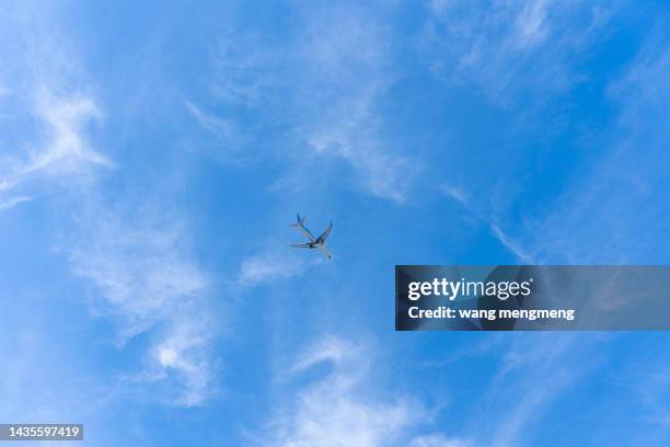 a plane flying in the sky - clear sky plane stock pictures, royalty-free photos & images