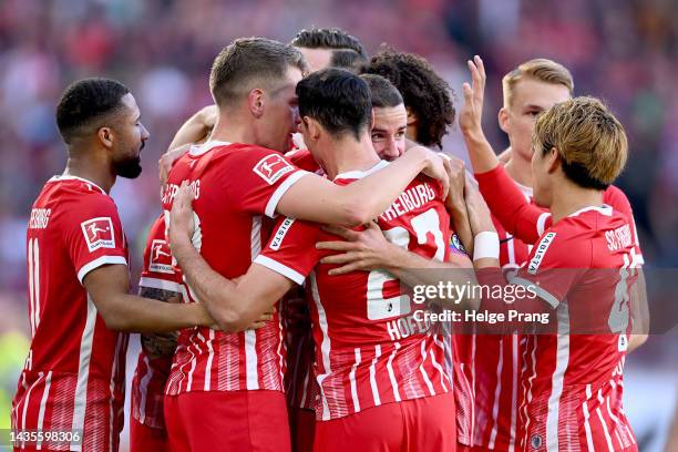 Lukas Kuebler of SC Freiburg celebrates with teammates after scoring their team's first goal during the Bundesliga match between Sport-Club Freiburg...