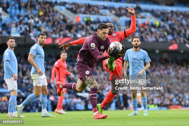 Ederson of Manchester City is challenged by Danny Welbeck of Brighton & Hove Albion during the Premier League match between Manchester City and...