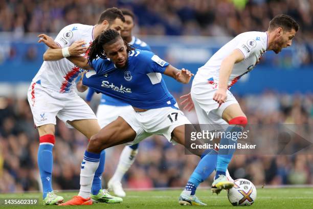 Alex Iwobi of Everton battles for possession with Luka Milivojevc and Joel Ward of Crystal Palace during the Premier League match between Everton FC...