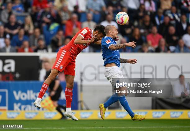 Noussair Mazraoui of Bayern Munich jumps for the ball with Angelino of TSG 1899 Hoffenheim during the Bundesliga match between TSG Hoffenheim and FC...