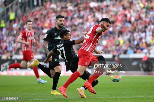 Vincenzo Grifo of SC Freiburg is fouled by Felix Agu of SV Werder Bremen leading to a penalty during the Bundesliga match between Sport-Club Freiburg...