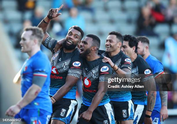 Ben Nakubuwai of Fiji celebrates with teammates after scoring their team's seventh try during the Rugby League World Cup 2021 Pool B match between...