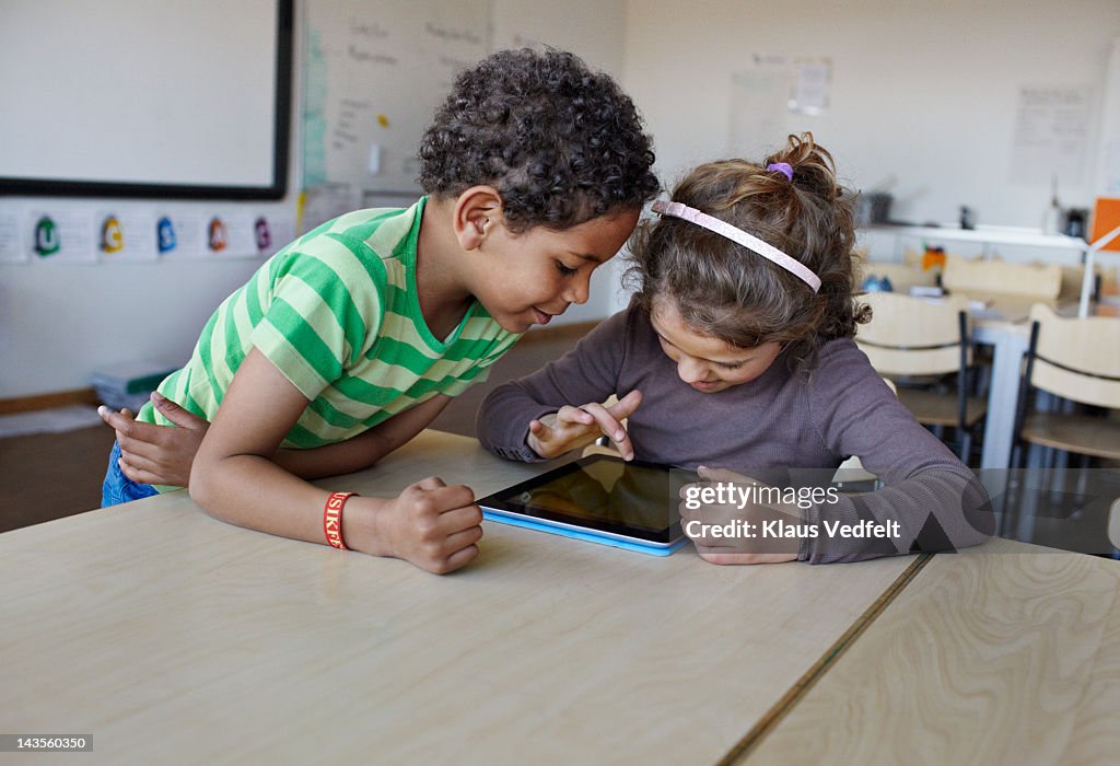 2 Kids using tablet in classroom