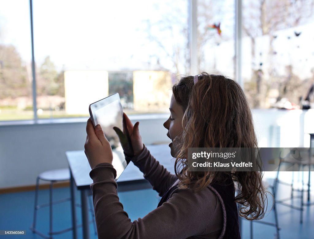 Girl in silhuet holding a tablet