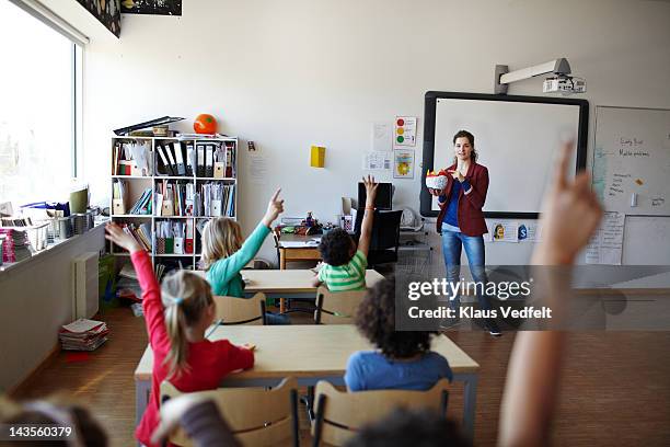 teacher in front of a class of raised hands - school denmark stock pictures, royalty-free photos & images