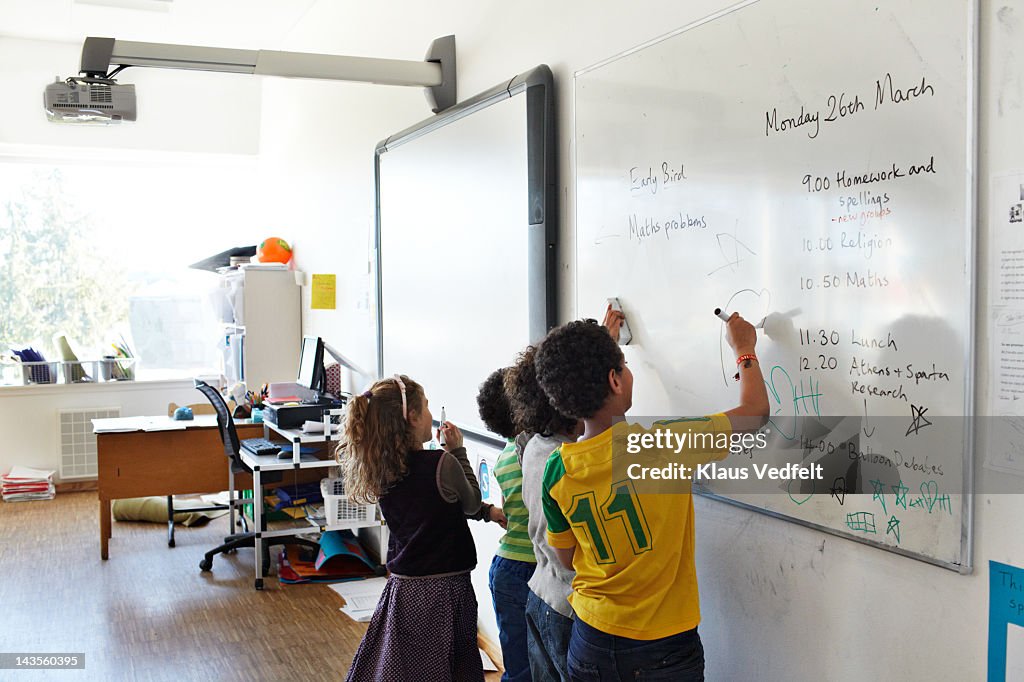 Kids drawing on whiteboard