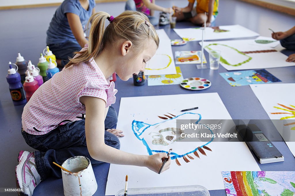 Girl painting in schoolclass