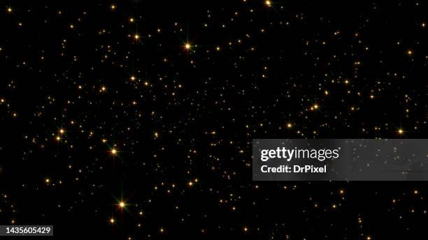 glittering golden particles - sparks stock photos et images de collection