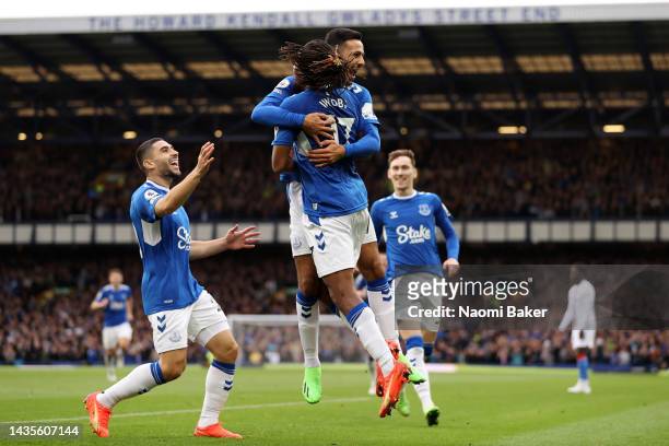 Dwight McNeil of Everton celebrates with teammate Alex Iwobi after scoring their team's third goal during the Premier League match between Everton FC...