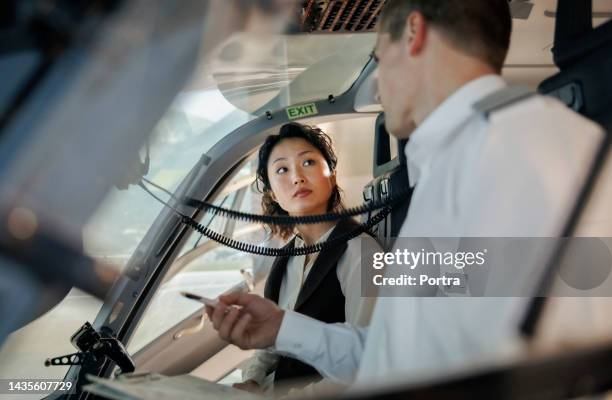 pilot talking with co-pilot in the cockpit during helicopter simulation training - pilot simulator stock pictures, royalty-free photos & images