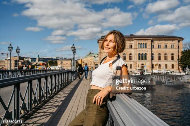 young woman on the bridge in stockholm - stockholm boat stock pictures, royalty-free photos & images