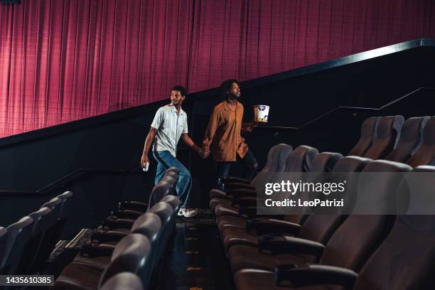 couple entering the theater to enjoy a movie together - couple entering the theater stock pictures, royalty-free photos & images