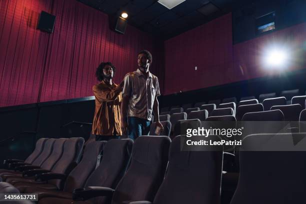 couple entering the theater to enjoy a movie together - couple entering the theater stock pictures, royalty-free photos & images