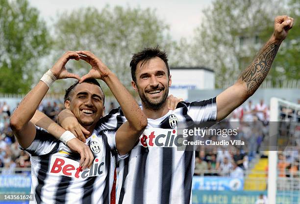 Arturo Vidal and Mirko Vucinic of Juventus FC celebrates scoring the third goal during the Serie A match between Novara Calcio and Juventus FC at...