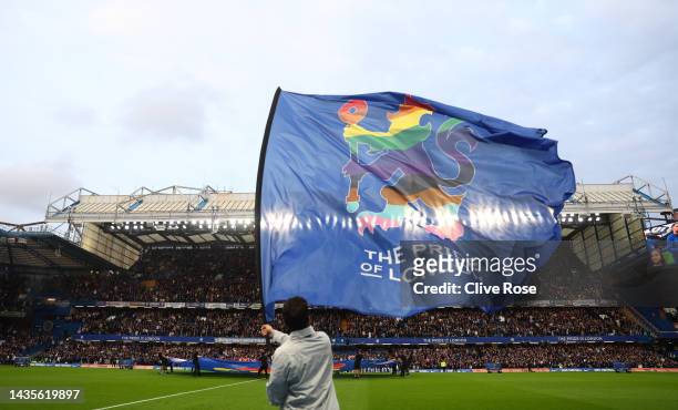 Flag bearer waves a Rainbow Chelsea flag prior to the Premier League match between Chelsea FC and Manchester United at Stamford Bridge on October 22,...