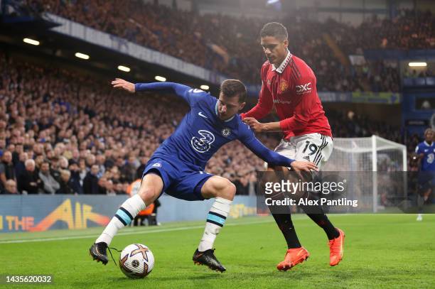 Mason Mount of Chelsea battles for possession with Raphael Varane of Manchester United during the Premier League match between Chelsea FC and...