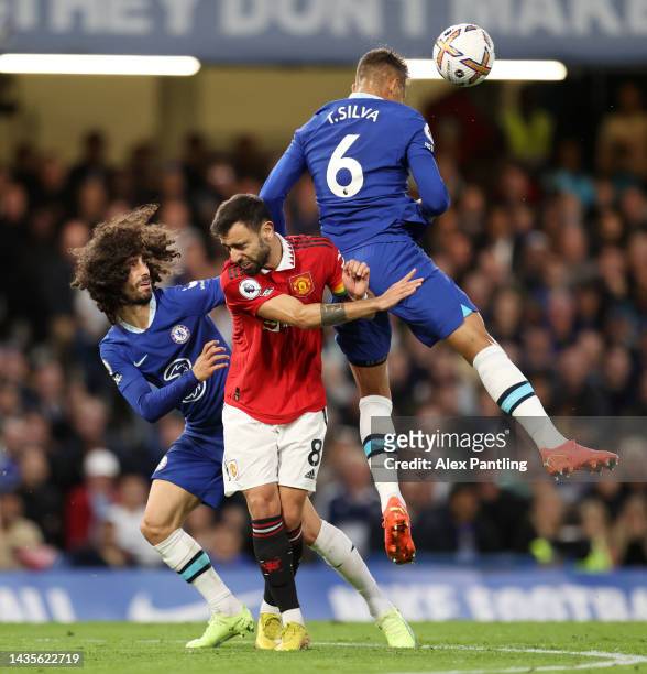 Marc Cucurella and Thiago Silva of Chelsea battle for possession with Bruno Fernandes of Manchester United during the Premier League match between...