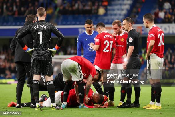 Raphael Varane of Manchester United receives medical attention during the Premier League match between Chelsea FC and Manchester United at Stamford...