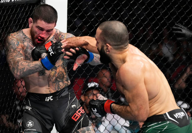 Belal Muhammad punches Sean Brady in a welterweight fight during the UFC 280 event at Etihad Arena on October 22, 2022 in Abu Dhabi, United Arab...
