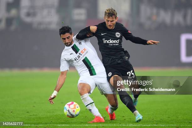 Lars Stindl of Borussia Monchengladbach is challenged by Jesper Lindstrom of Eintracht Frankfurt during the Bundesliga match between Borussia...