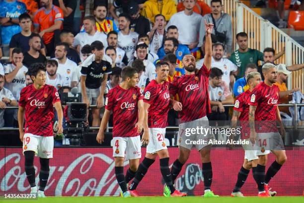 Vedat Muriqi of RCD Mallorca celebrates with teammates after scoring their team's first goal from the penalty spot during the LaLiga Santander match...