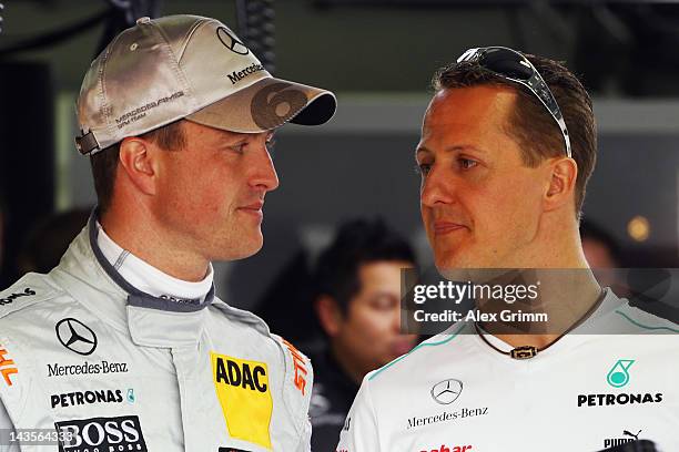 Michael Schumacher and his brother Ralf chat prior to the first race of the DTM German Touring Car Championship at Hockenheimring on April 29, 2012...