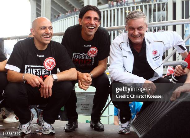 Kit manager Franco Lionti, sporting manager Bruno Huebner and head coach Armin Veh of Frankfurt celebrate the ascent to the 1. Bundesliga after the...