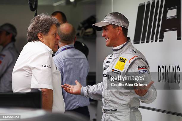 Norbert Haug, director of Mercedes Motorsport, chats with Mercedes AMG driver Ralf Schumacher prior to the first race of the DTM German Touring Car...