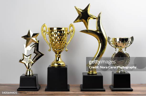 trophies in a rows on top of office desk - awards winners room stock-fotos und bilder