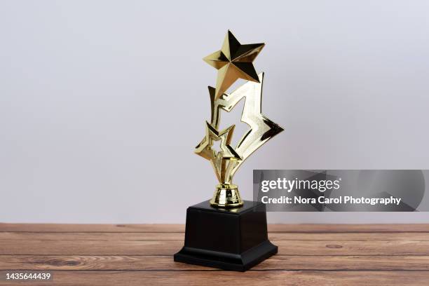 gold trophy with star shape - first light awards inside stock pictures, royalty-free photos & images