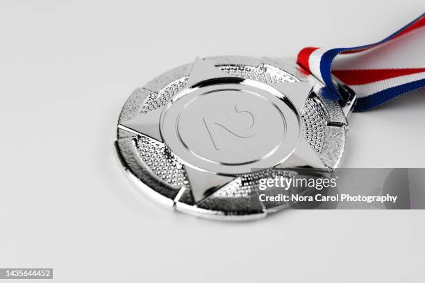 silver medal on white background - medal foto e immagini stock