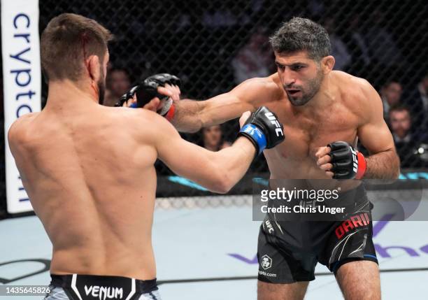 Beneil Dariush of Iran punches Mateusz Gamrot of Poland in a lightweight fight during the UFC 280 event at Etihad Arena on October 22, 2022 in Abu...