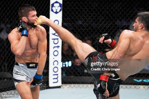 Beneil Dariush of Iran kicks Mateusz Gamrot of Poland in a lightweight fight during the UFC 280 event at Etihad Arena on October 22, 2022 in Abu...