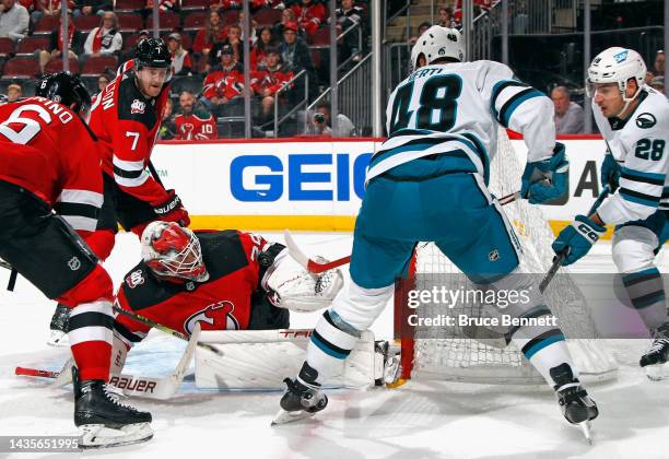 Mackenzie Blackwood of the New Jersey Devils makes the save on Tomas Hertl of the San Jose Sharks late in the third period at the Prudential Center...