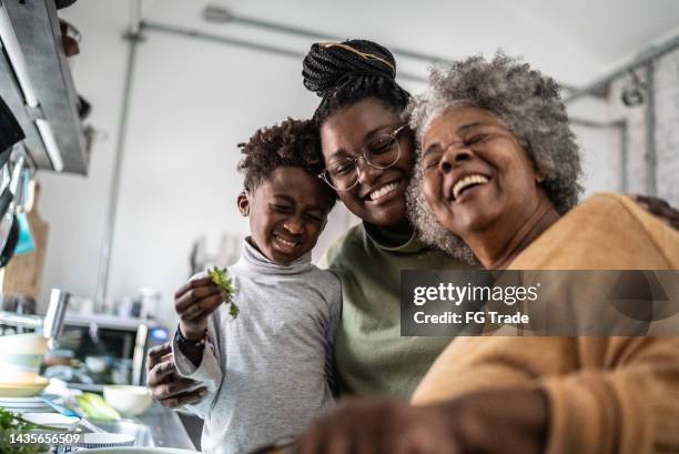 happy family cooking at home - grandmother son stock pictures, royalty-free photos & images